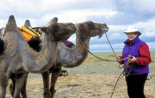 Helen Thayer on one of her adventures holding the leads for two camels
