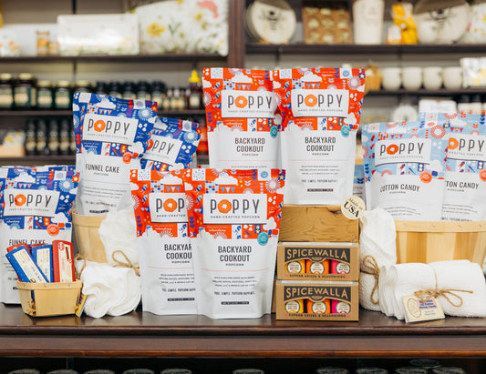 Poppy Hand-crafted Popcorn and Spicewalla products displayed in a store setting for Made in USA.