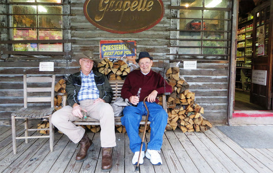 Two visitors enjoying a cold drink on the swing at the Original Store
