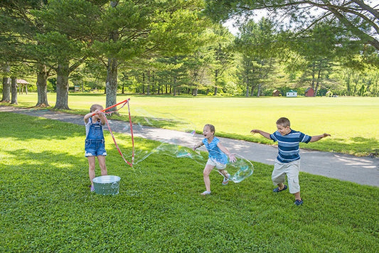 Children playing outside with bubbles