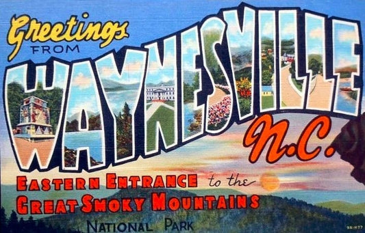 A vintage postcard depicting Greetings from Waynesville, NC the eastern entrance to the Great Smoky Mountains National Park