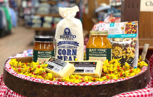 A collection of food products sitting atop a barrel of Bit-O-Honey candy.