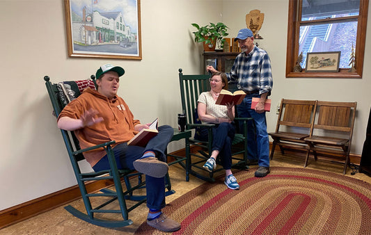 A group engaged in a lively discussion of books.