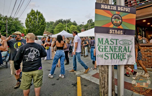People walking through the Boonerang Festival happening in Downtown Boone