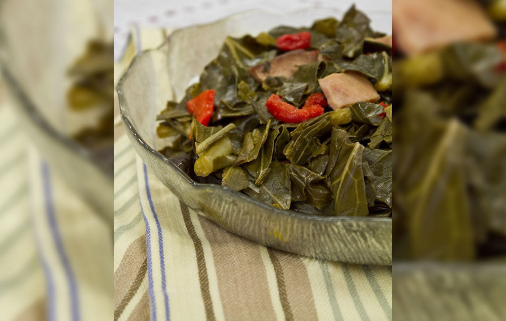 A bowl of collard greens on a table