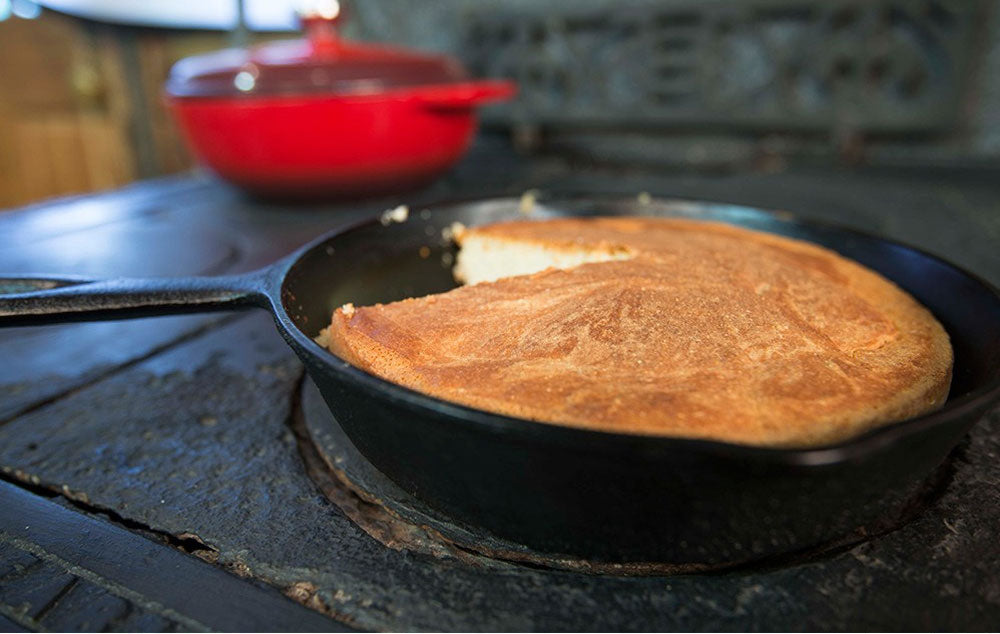 Cornbread in a cast iron skillet on an old fashiones stove