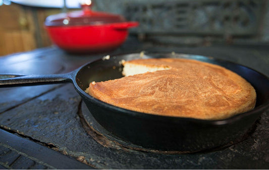 Cornbread in a cast iron skillet on an old fashiones stove