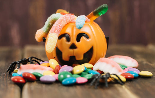 Halloween Candy spilling out of a plastic jack-O'lantern