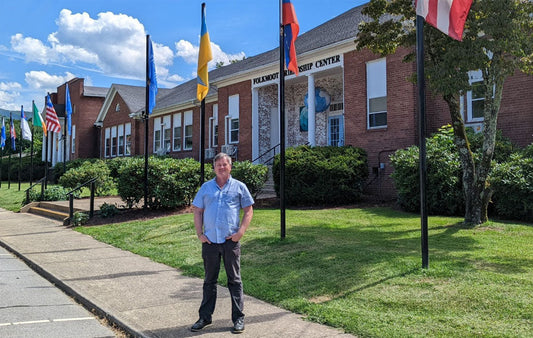 Folkmoot Executive Director Evan Hatch standing in front of the Folkmoot headquarters