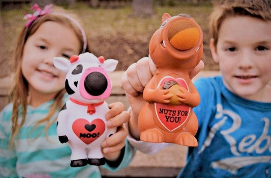 Two children with Squirrel Popper and cow popper squeeze toys