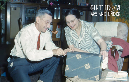 Couple opening a gift circa 1950s