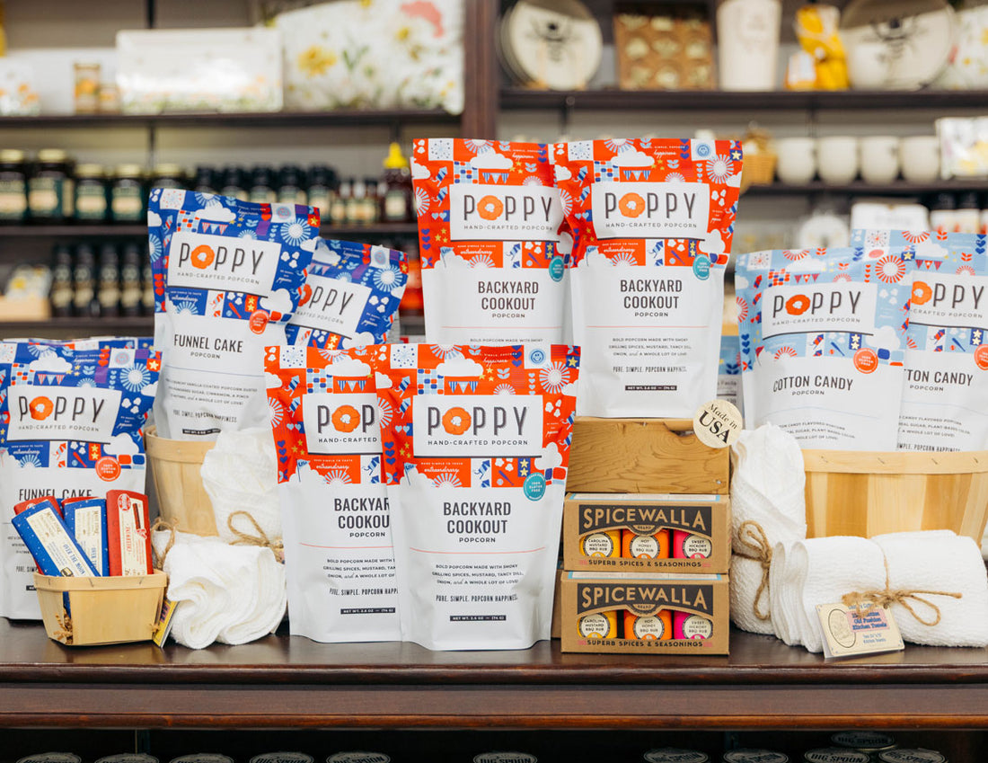 Poppy Hand-crafted Popcorn and Spicewalla products displayed in a store setting for Made in USA.
