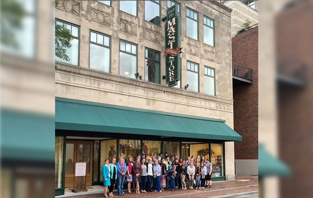 Guests and staff standing in front of the Winston-Salem Mast Store during theGrand Opening