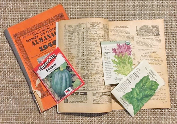 A picture of seed packets on an open copt of the Farmer's Almanac