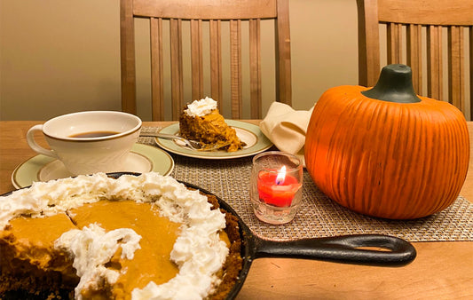 Skillet Pumpkin Pie on a Table with a pumpkinCenterpiece