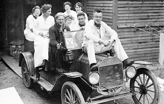 Eight people in an open car circa 1920s
