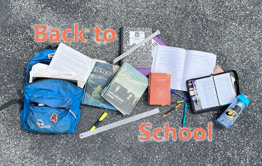 A grouping of scjool supplies including a bookbag, notebooks pens, pencils and a waterbottle.