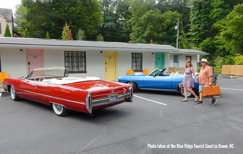Couple walking toward a convertable at a motor court