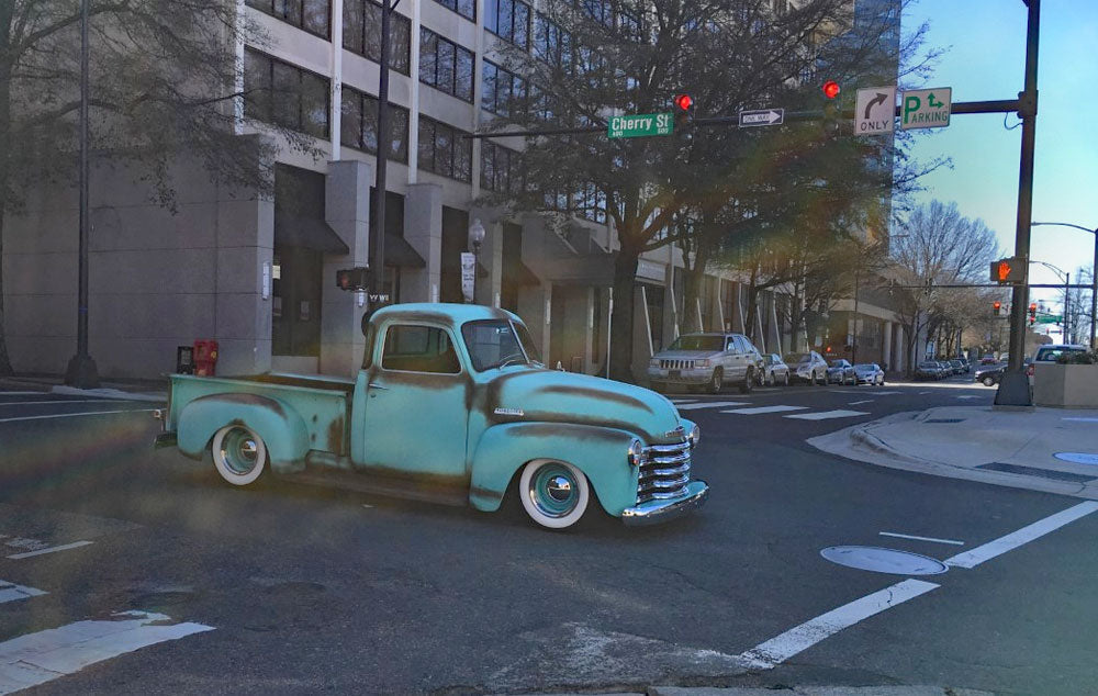 A vintage truck drives through the streets in Winston-Salem
