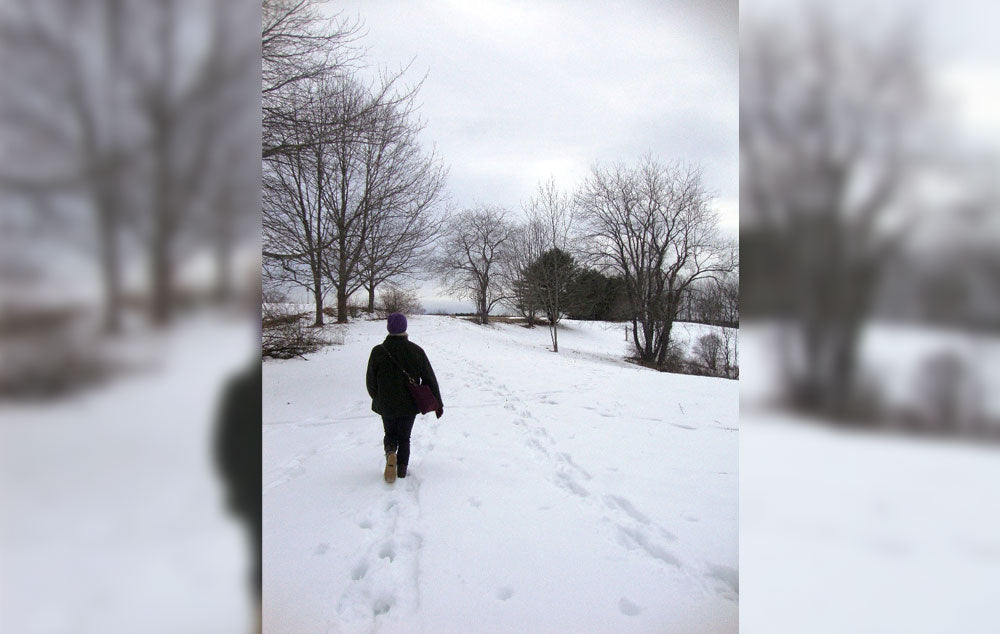 A hiker walking through the snow