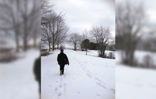 A hiker walking through the snow