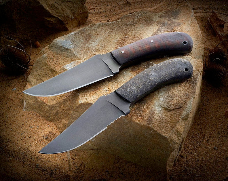 Two Winkler Knives displayed on a rock