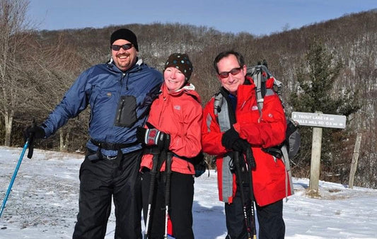 Three hikers in a snowy meadow off the Blue Ridge Parkway