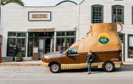 Lisa Cooper, president of Mast General Store, stands with L.L.Bean boot in front of the Original Mast Store in Valle Crucis.