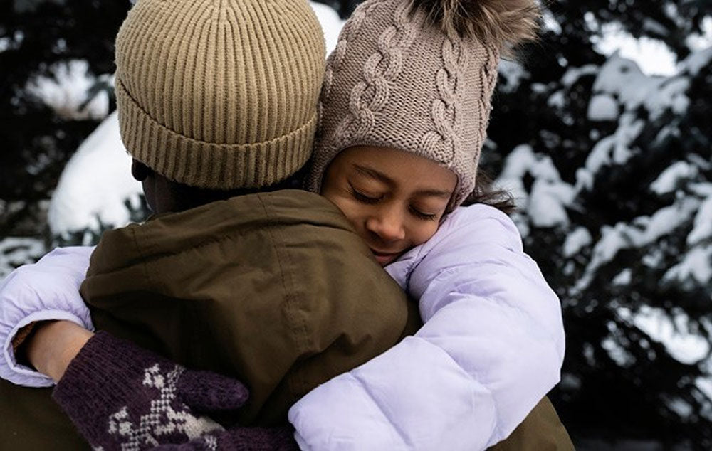 Two people sharing a Holiday Hug