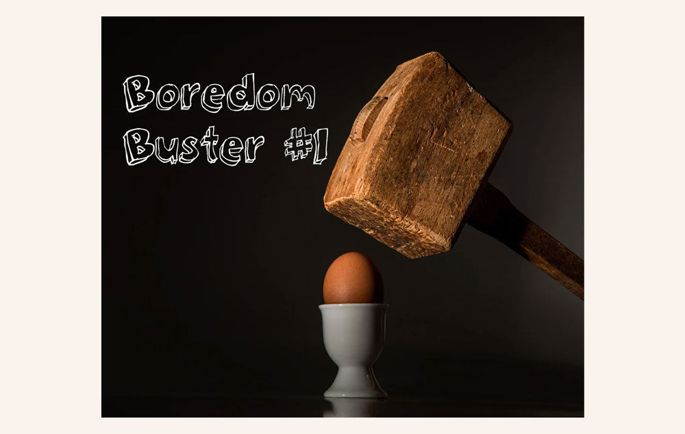 A large wooden hammer about to smash an egg.