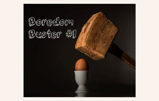 A large wooden hammer about to smash an egg.