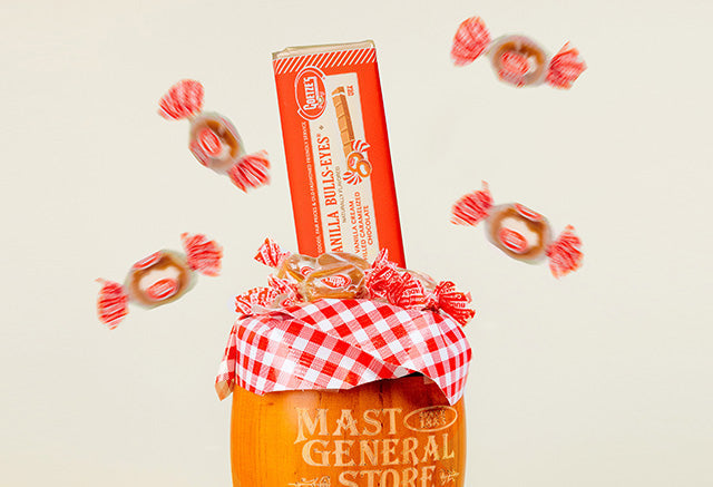Mast Store's Vanilla Bulls-Eyes Candy Bar atop a barrel filles with bullseye candies