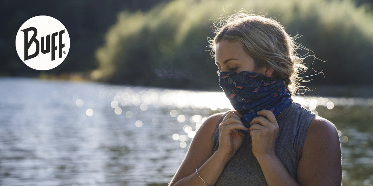 Person wearing a Buff brand product by a lake.