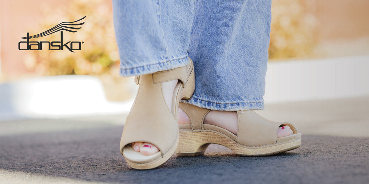 A person wearing a pair of Dansko sandals.