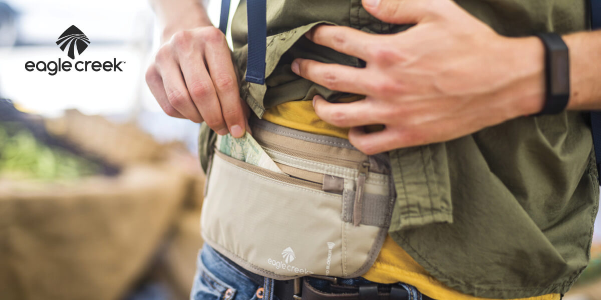 A person taking money out of a Eagle Creek money belt.
