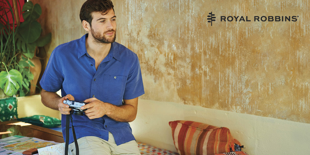 Man holding a camera while wearing a Royal Robbins Desert Pucker shirt.