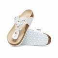 White floral flip-flop sandals with a cork sole, featuring a comfortable footbed and decorative flower embellishments, perfect for summer outings.