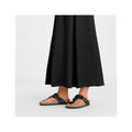 Stylish women's sandals featuring floral details and a comfortable cork sole, paired with a flowy black maxi dress for a chic summer look.