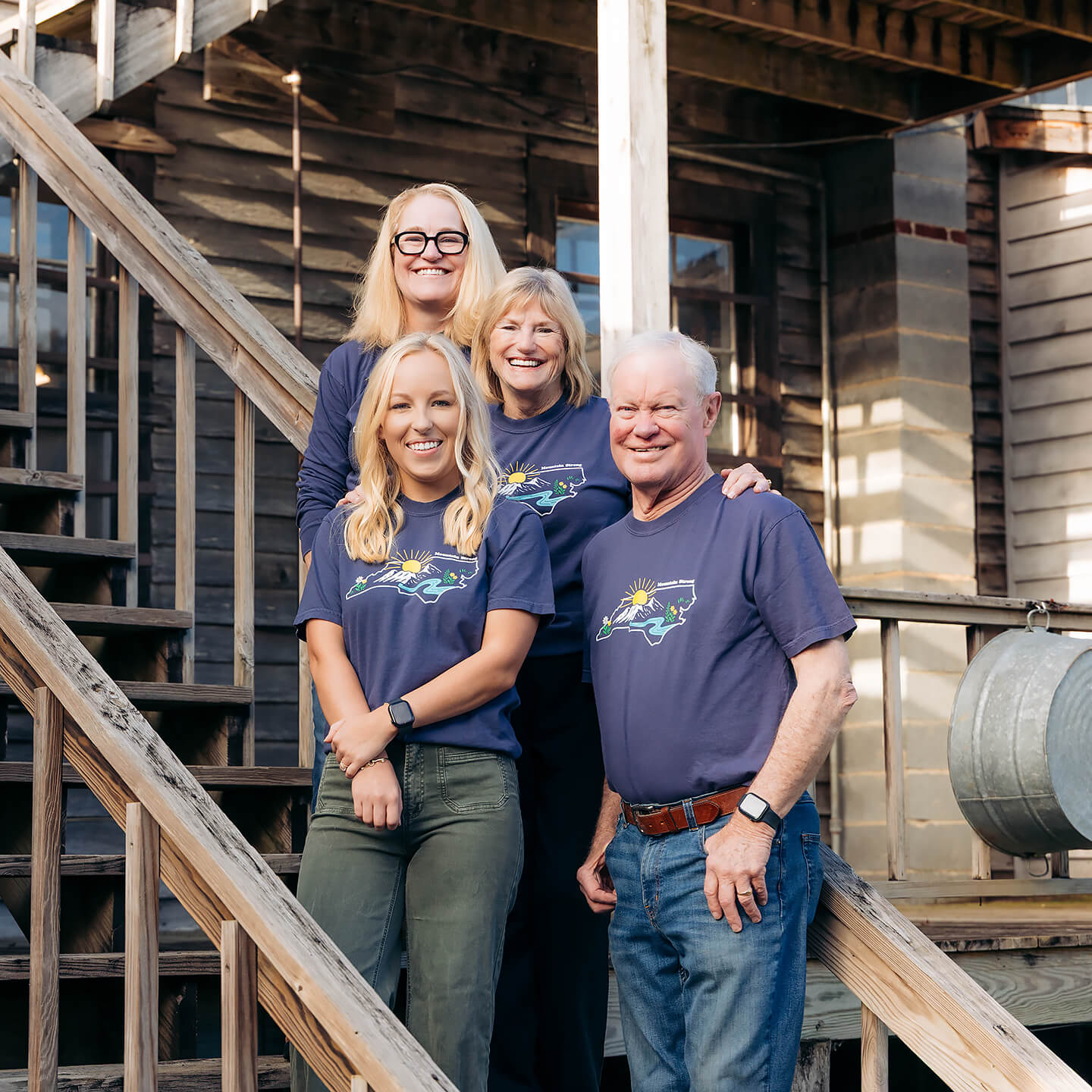 The Cooper family is shown sporting Mountain Strong t-shirts on the steps at the Original Store.