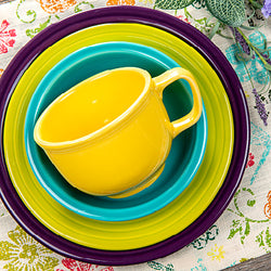 Vibrant Fiesta dinnerware displayed on a floral tablecloth