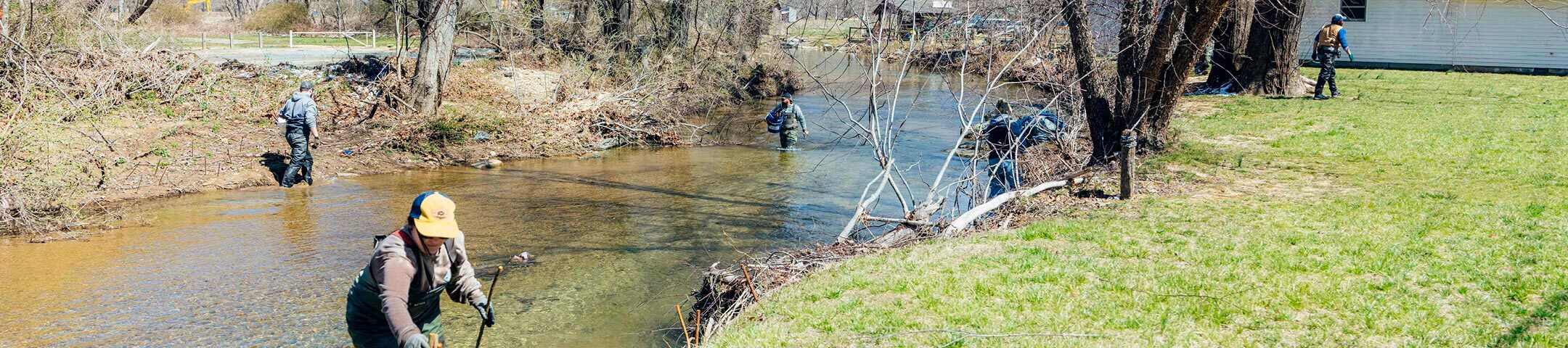 Mast Store employees volunteering along the Watauga River in Valle Crucis, NC.
